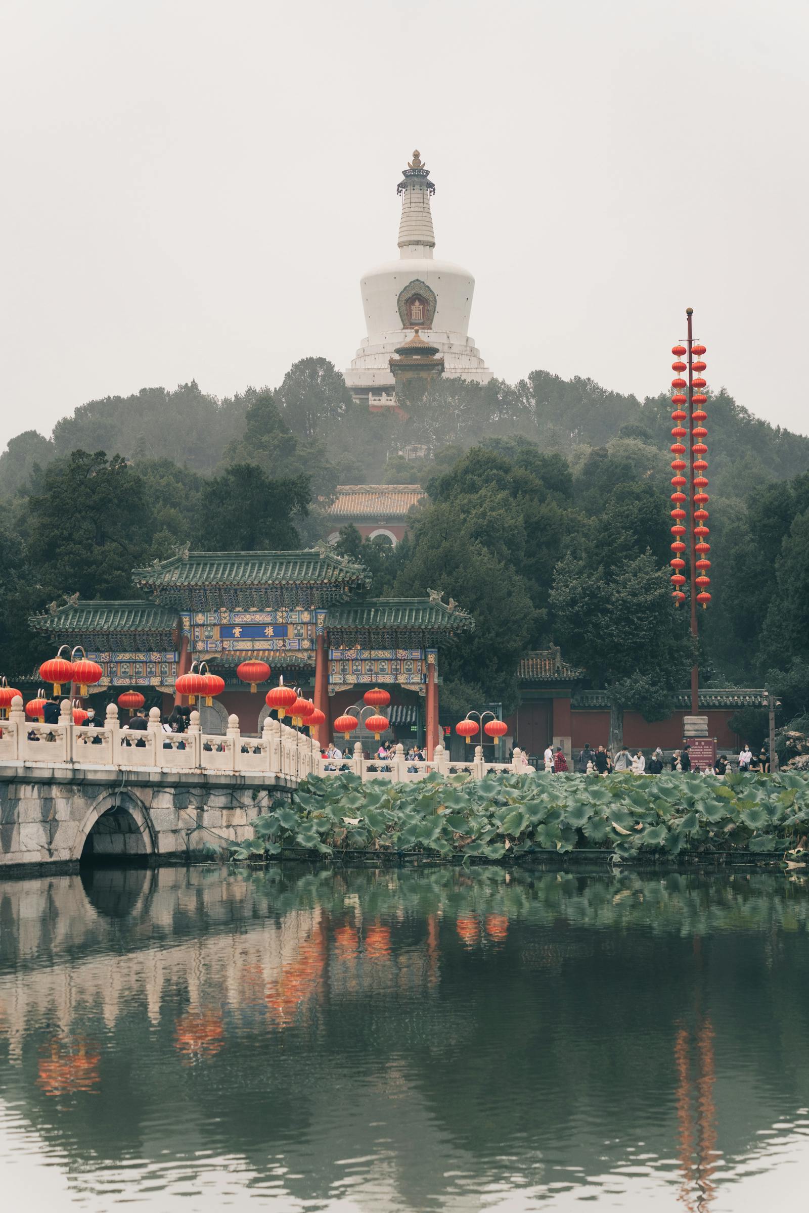 View of the White Pagoda from across Beihai Lake with willows in the foreground