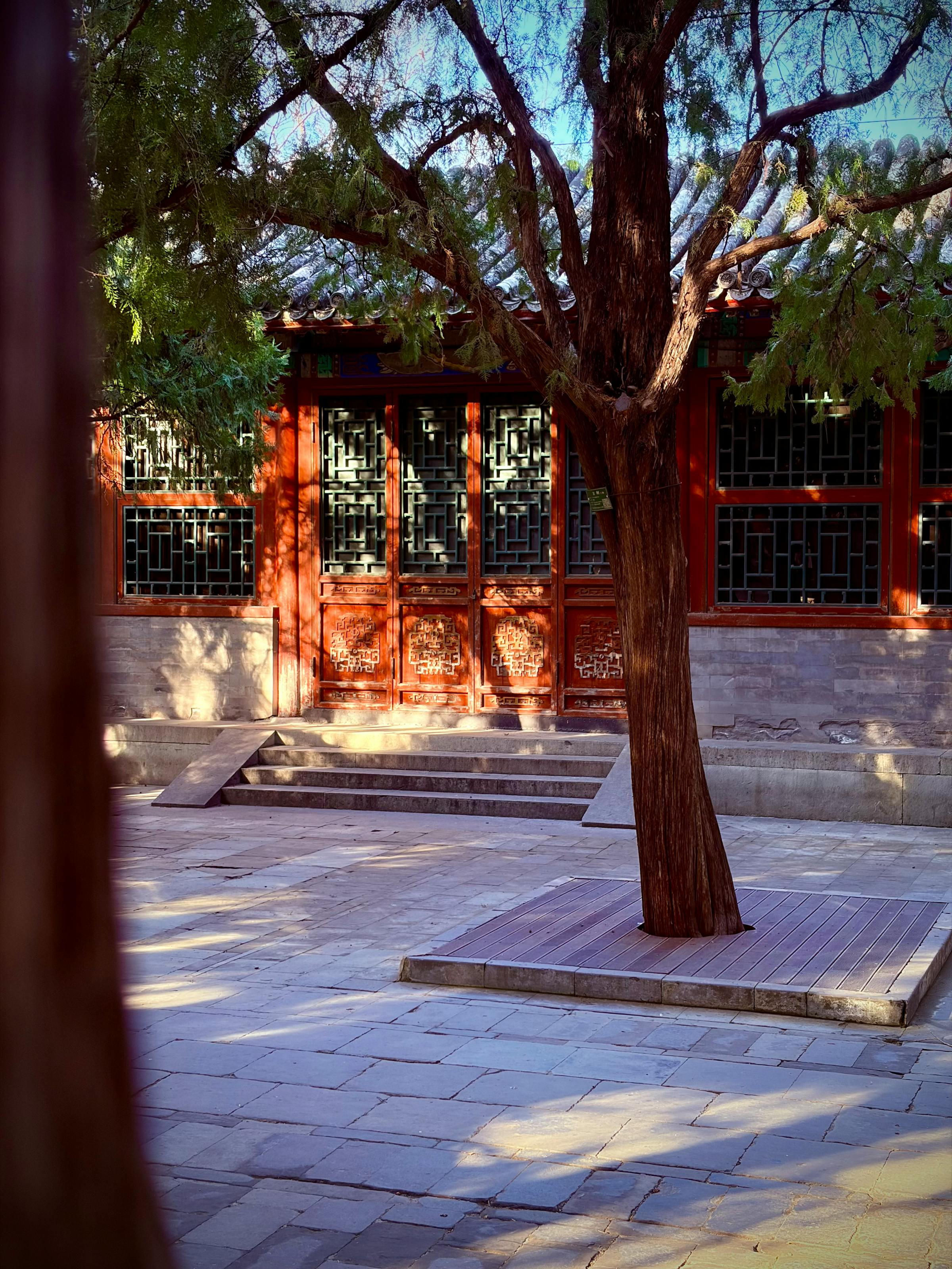 A restored siheyuan courtyard with grey-tiled roofs around a central open space